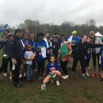 Student running team posing together